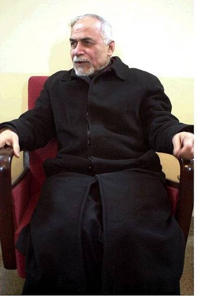 Basile Georges Casmoussa, 66, the Archbishop of the Syrian Catholic Church sits in a  chair after he arrived back to the church in Mosul, some 360 kilometers, (225 miles) north of Baghdad, Tuesday Jan. 18, 2005. The Archbishop, kidnapped in Iraq on Monday has been freed. A ransom of US$200,000 (153,478) initially had been demanded but the bishop was released without the payment of any money, the Vatican said. (AP Photo)