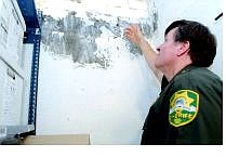 Lt. Ray Saylo of the Carson City Sheriff&#039;s Department points out an area of mold on the wall in the  evidence room in the basement of the sheriff&#039;s  building.  Rick Gunn Nevada Appeal