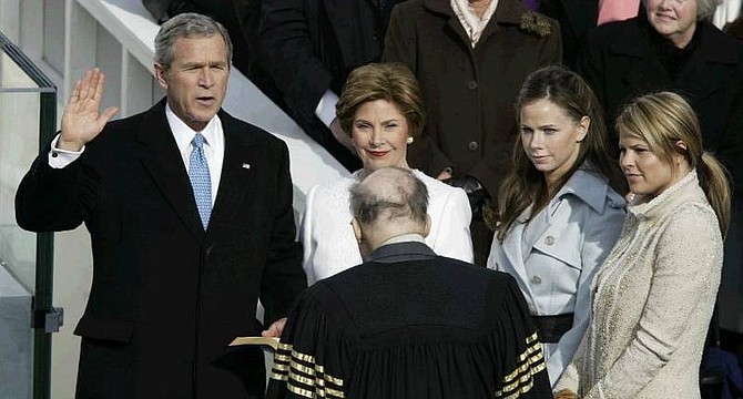 President Bush is sworn in by Chief Justice William Rehnquist during his inauguration on Capitol Hill Thursday, Jan.20, 2005. First lady Laura Bush holds the bible as daughters, Jenna, right, and Barbara look on. (AP Photo/Stephan Savoia)