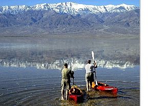 Associated Press Larry, left, and Carol Wade of Mukilteo, Wash., launch their kayaks about a half mile south of Badwater, Calif., in Death Valley Wednesday with Telescope Peak reflected in water from recent flooding. They waded out about a quarter mile and managed a bit of paddling, although scraping bottom most of the time.