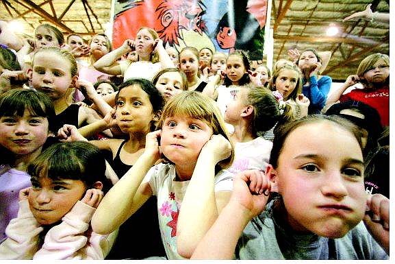 BRAD HORN/Nevada Appeal Baile Zuber, 8, from right, Erica Watson, 9, and Raquel Marchesseault, 9, make monkey faces in the Carson Middle School gym during rehearsal for the Young Americans on Friday.