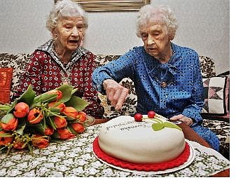 Twins Gunhild Gaellstedt, left, and Siri Ingvarsson cut their 100th anniversary birthday cake in Stockholm, Sweden, Friday. Sweden&#039;s oldest living pair of twins, they still do all their shopping, cooking and cleaning by themselves. Associated Press