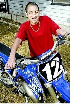 Cathleen Allison/Nevada Appeal Motocross rider Preston Malone displays his bike at his South Carson City home.