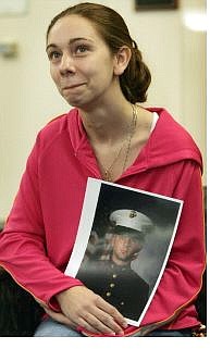 Melany LeBleu, wife of U.S. Marine Lance Cpl. Christopher LeBleu, holds her husband&#039;s portrait as she waits at Loma Linda University Medical Center in Loma Linda, Calif., Saturday. Her husband was in surgery Sunday to receive a new liver.  Associated Press