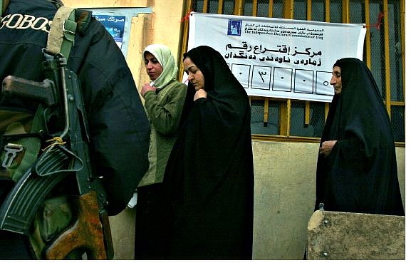 Associated Press Fatima Ibrahim, left, of the Kurdish Barzani tribe, 35, followed by her mother in law, Salha Omar, center, queues to cast their ballots for the Iraqi elections at a polling station in downtown Irbil Sunday. They are &quot;Anfal Women&quot; - widows and daughters of 8,000 Barzani men reportedly killed by Saddam Hussein during the 1980s.
