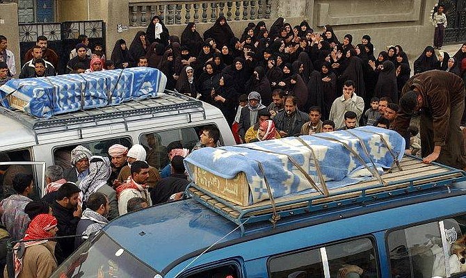 Family members and friends of Iraqi brothers Sabah, 22, and Diyaa Sayid, 21, mourn as their coffins are loaded onto cars for a funeral ceremony in Sadr City, Baghdad, Tuesday, Feb.1, 2005. The two brothers where killed when a mortar landed next to a polling station in Sadr City on Sunday while they queued to vote in Iraqi&#039;s first free election in a half-century. (AP Photo/Karim Kadim)