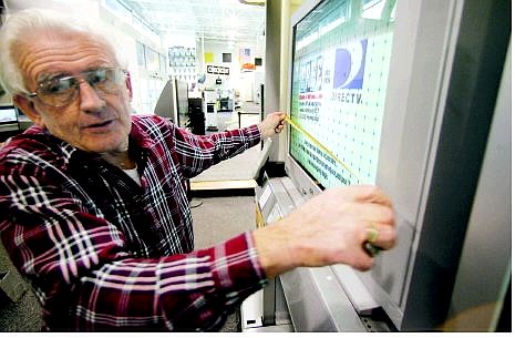BRAD HORN/Nevada Appeal Alan Kidney, of Gardnerville Ranchos, measures a television for his home while shopping at Best Buy with his wife of 53-years, Valerie, Friday morning.