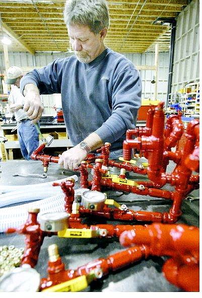 Cathleen Allison/Nevada Appeal Chuck Fulcher of Rice Hydro Inc. assembles a gauge for a water pressure testing pump at the Carson City warehouse Wednesday morning. The company recently expanded to include fabrication at its Carson City location.