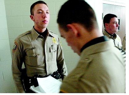 Rick Gunn/Nevada Appeal Sean Drew, 20 stands at attention while having his appearance scored at the Carson City Sheriff&#039;s Explorer meeting Tuesday evening. He is being inspected by Explorer captain Brett Bindley, 17.