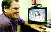 Carson City Fire Capt. Bob  Schreihans  watches a tape of his daughter, Amanda Avila ,auditioning for &#039;American Idol.&#039;  Avila made the  initial cut on the Fox  program.