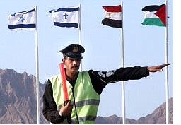 Amr Nabil/Associated Press An Egyptian traffic police officer gestures in front of, from left, the flags of Israeli, Egypt and the Palestinian Authority Monday in the Red Sea resort city of Sharm el-Sheik, Egypt, where leaders will meet for a summit.