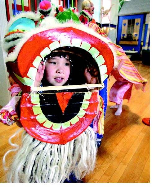 BRAD HORN/Nevada Appeal Hannah Hope, 4, of Carson City, dances around inside a dragon at the Children&#039;s Museum.