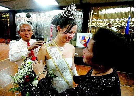 Leah Rose Robinson is congratulated by Warly and Nora Pizarro after receiving her crown at the Carson Nugget on Saturday for Miss Filipino American Association of Carson City.    BRAD HORN Nevada Appeal