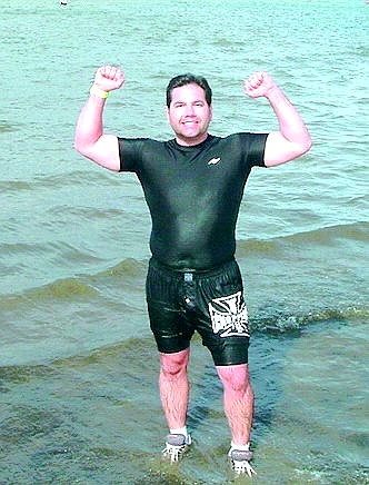 Ted Rupert, owner of Rupert&#039;s Auto Body, strikes a muscle man pose after completing the Polar Bear swim at Lake Tahoe Sunday. The swim was a fund-raiser for the Special Olympics. contributed photo