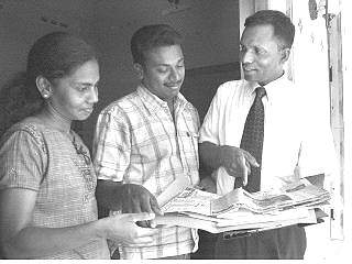 Murugupillai Jeyarajah, center, and Jenita Jeyarajah, left, confirmed by DNA tests to be the parents of &#039;Baby 81,&#039; talk to their lawyer S. Manarudeen, right, at their residence in Kalmunai, Sri Lanka, Monday.  Eranga Jayawardena Associated Press