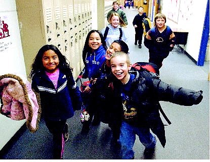 BRAD HORN/Nevada Appeal From left, Kennea Gonzalez, 8; Amber Gandara, 8; Alex Fernandez, 9, and Brandon Acero, 8, walk out of Mrs. Nicole Medeiros&#039; third-grade classroom  at Bordewich-Bray Elementary School Friday after school let out. Tuesday night, Carson City School Board trustees will examine the results of a preliminary vote to convert the school to a year-round schedule.