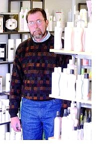 Jack McGinnis, co-owner of CJ.&#039;s Beauty Supply and Salon, stands near some of his products.   Rick Gunn Nevada Appeal