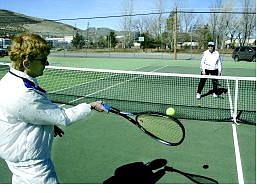 Liz Neumann and Diane Cox play tennis at Ross Gold Park Monday  morning. The Ross Gold tennis courts could receive $30,000 in repairs from the city&#039;s five-year capital improvement plan.  Cathleen Allison Nevada Appeal