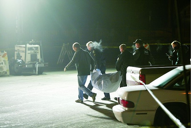 Photo by Josh Miller/Sierra SunTruckee police carry the body of a woman found in a parking lot in Tahoe Donner on Monday.