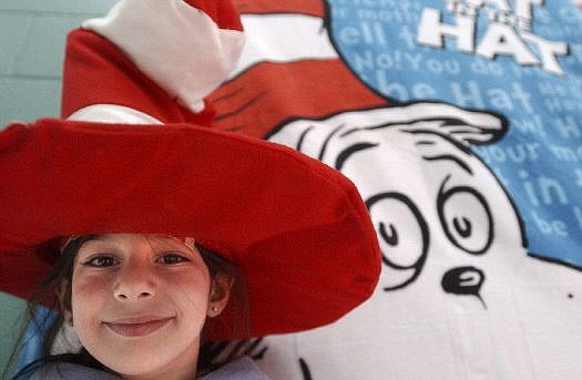 Rick Gunn/Nevada Appeal Sabrina Daou matches hats with a rendering of Dr. Seuss&#039; &quot;Cat In the Hat&quot; during a celebration of Seuss&#039; birthday at Mark Twain Elementary School on Wednesday.