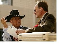Chief Raymond Yowell of the Western Shoshone Nation, left, confers with tribal attorney Robert Hager, at the U.S. Federal Courthouse in Las Vegas on Friday. The tribe filed a lawsuit against the federal government saying a 19th century treaty with the feds prohibits building a nuclear dump on the Yucca Mountain site. Joe Cavaretta/Associated Press