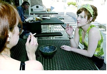Cathleen Allison/Nevada Appeal  Western Nevada Community College students Jennifer Dunn, left, and Kaysea Johnson smoke during their break from their jobs at the Java Joe&#039;s campus coffee shop Wednesday afternoon. The Nevada Assembly on Wednesday said it will let voters decide between two initiative petitions that would tighten restrictions on smoking in public areas.