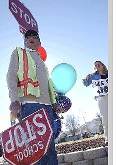 Rick Gunn/Nevada Appeal Seeliger crossing guard Joe Terzyk stands near Seeliger Elementary School with Seeliger principal Laurel Terry on Friday during his last cross-walk duty. Joe was retired after tending the cross walks since 1998 and his retirement was celebrated by kids, adults and passersby.