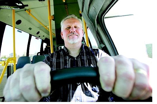 BRAD HORN/Nevada Appeal Mike Delude, the new transit planner for Carson City, poses in the driver&#039;s seat of one of the fleet of buses Thursday.