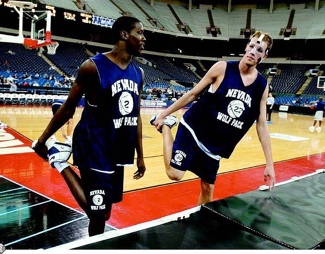 Nevada&#039;s Mo Charlo, left, and Nick Fazekas talks as the stretch out during practice for the first round of the NCAA Tournament in Indianapolis, Wednesday, March 16, 2005. Nevada plays Texas in the first round Thursday. (AP Photo/Darron Cummings)