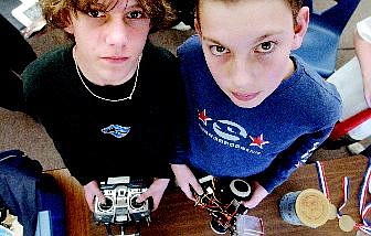 Seventh-graders Wes Deitlein, left, and Robbie Ardinger hold their robo-billiards, which took first place in at the Science Olympiad in Las Vegas recently.    Rick Gunn Nevada Appeal