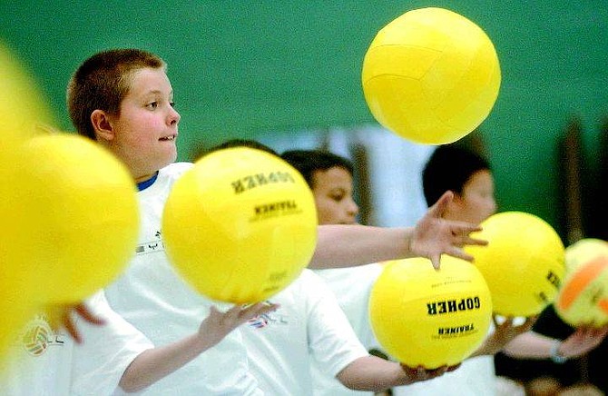 Rick Gunn/Nevada Appeal Jesse Cowdell, 9, practices his volleyball serve during the after-school intrarmural vollleyball club at Mark Twain Elementary School Tuesday.