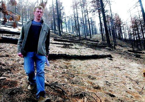 Rick Gunn/Nevada Appeal Carson City Life Scout Mike Otterstrom walks down the steep banks of the Waterfall fire burn area above his Lakeview neighborhood Tuesday. Otterstrom will plant 1,000 Jeffery pines on 50 acres as part of his Eagle Scout project in mid-April.