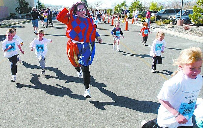 BRAD HORN/Nevada AppealJennifer Tarten, dressed as the jester, runs with the children during the kid&#039;s run of the Jester Jog at Pinon Plaza last year. Lindy Lehman, 6, of Carson City, right front, takes the lead and eventually won the race in her division.