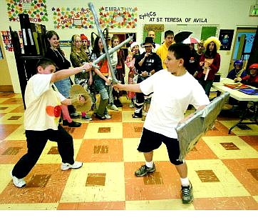 BRAD HORN/Nevada Appeal Robert Reil, right, and Noel Lopez fight during the Medieval Museum event at St. Teresa of Avila School on Friday. The 12-year-olds are in Kara Evans&#039; class, which created the museum as part of its history lessons.