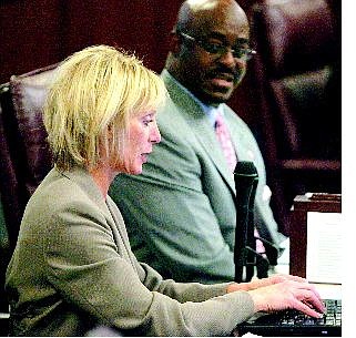 Brad Horn/Nevada Appeal Sen. Sandra Tiffany, R-Las Vegas, works on her laptop during session in the Senate Chambers while Sen. Maurice Washington, R-Reno, watches on Thursday.
