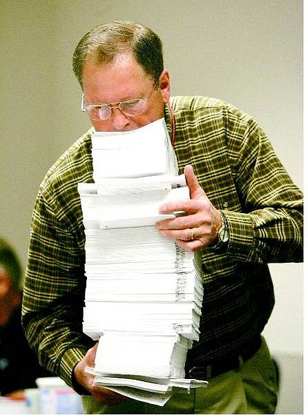 BRAD HORN/Nevada Appeal Norm Budden, Assembly bill room director, carries a stack of bills that need to be bound to a table Friday morning.