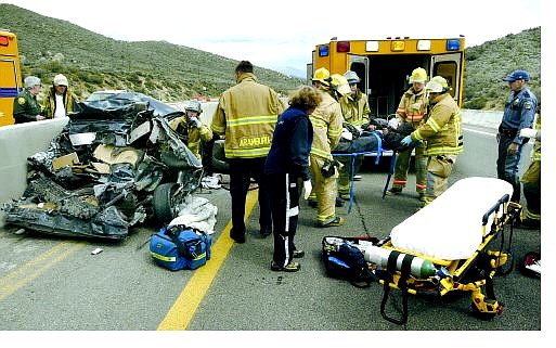 Cathleen Allison/Nevada Appeal Emergency personnel extricate an unidentified man from his car following a two-vehicle accident on Lakeview Hill Monday afternoon. He was transported by Care Flight to Washoe Medical Center in Reno.