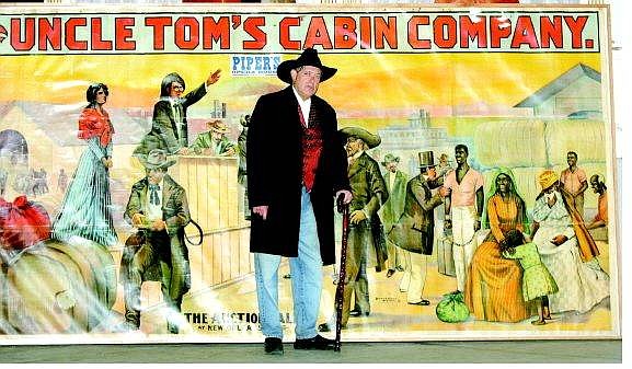 Sam Folio stands in front of a  promotional poster for &quot;Uncle Tom&#039;s Cabin&quot; at Piper&#039;s Opera House in VIrginia City Sunday.  BRAD HORN Nevada Appeal