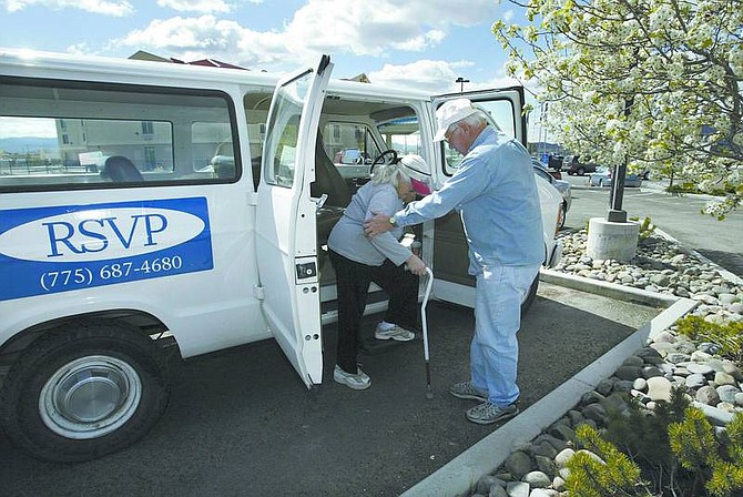 Cathleen Allison/Nevada Appeal RSVP driver Bill Fehr helps Elizabeth Mackey out of a van Wednesday morning in North Carson City. The volunteer program provides transportation service to Dayton seniors.
