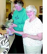 Rhonda Costa-Landers/ Nevada Appeal Fun with Fashion Chairwoman Barbara Hancock, left, looks over raffle and door prizes Wednesday at the Carson City Senior  Citizens Center.