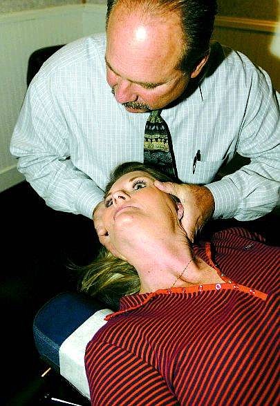 Dan Thrift / Nevada Appeal News Service Paul Whitcomb, a chiropractor, realigns the top vertebra of Lori Stennett, of Fort Stockton, Texas, to treat her fibromyalgia in his office at South Lake Tahoe. Ninety percent of the 6 million victims of the disease are women.