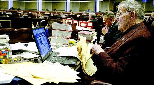 Cathleen Allison/Nevada Appeal Nevada Assemblyman John Marvel, R-Battle Mountain, sorts through the piles of amendments at his desk on the Assembly floor, Monday at the Legislature as lawmakers face a deadline for action on pending bills.