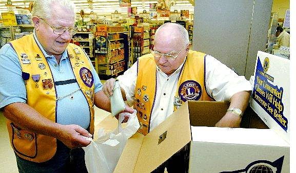 Cathleen Allison/Nevada Appeal John Dickenson, left, and Jim Capistrant collect donated glasses at the Dayton Smith&#039;s pharmacy Monday afternoon as part of the Dayton Valley Lions Club program that recycles discarded glasses and sends them overseas.