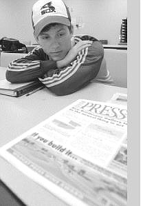 Western Nevada Community College journalism student Tim Walsh looks over the spring copy of the Wildcat Press. The newspaper won third place for best all-around magazine published more than once a year in the Society of Professional Journalists Awards of Excellence. The third issue of the newspaper came out this week at the college.   Rick Gunn Nevada Appeal
