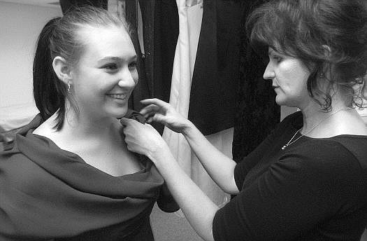 Rick Gunn/Nevada Appeal Kim Riggs, homeless advocate for the Carson City School District, puts the finishing touches on the prom dress of Shanda Combs, 17, at Carson High School on Wednesday. Combs was not planning on attending the prom until Riggs came through with a dress and prom ticket.