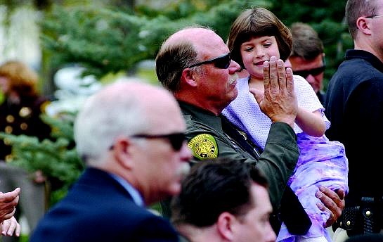 Rick Gunn/Nevada Appeal Washoe County Deputy Rick Pillon gives a high five to Heather Wiberg, 7, at the Nevada Law Enforcement Memorial Ceremony. Heather&#039;s father, Deputy John Wiberg II, was killed in a car accident May 11, 2004, as he responded to a robbery.