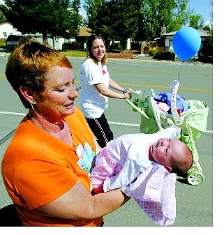 BRAD HORN/Nevada Appeal Linda Martin holds her 3-week-old granddaughter Kaitlynn Glory Plummer while the proud mother Gena pushes her stroller during the March of Dimes Walk in Carson City on Saturday morning. Kaitlynn was born one week premature.