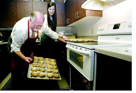 Ben Graham and his daughter  Caroline make cookies at the Legislature in Carson City on Tuesday  morning.  Graham, a  lobbyist for the Nevada District Attorneys&#039;  Association, makes an  estimated 1,100 cookies on his traditional &quot;Day of a Thousand Cookies.&quot;  Graham  estimates he uses 70 pounds of flour, 20 pounds of  margarine and 120 cups of chocolate chips.  Cathleen Allison Nevada Appeal