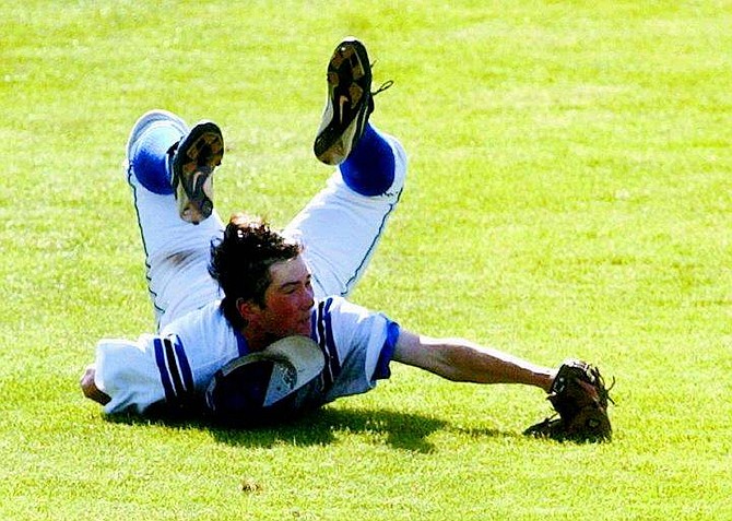 Carson High school left fielder Alex Tanchek makes a diving catch against a Reno Huskie hitter during the 4A Zone playoffs at Ron McNutt Field in Carson City, Nev., on Thursday, May 12, 2005. AP Photo Brad Horn/Nevada Appeal