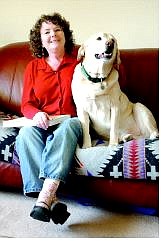 Sandra Marshall sits on her couch with her yellow Lab, Roger, at her home, where she runs Marshall Historical Consulting.   Rick Gunn/Nevada Appeal